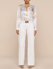 Model wearing L'AGENCE Tyler blouse styled with white pants