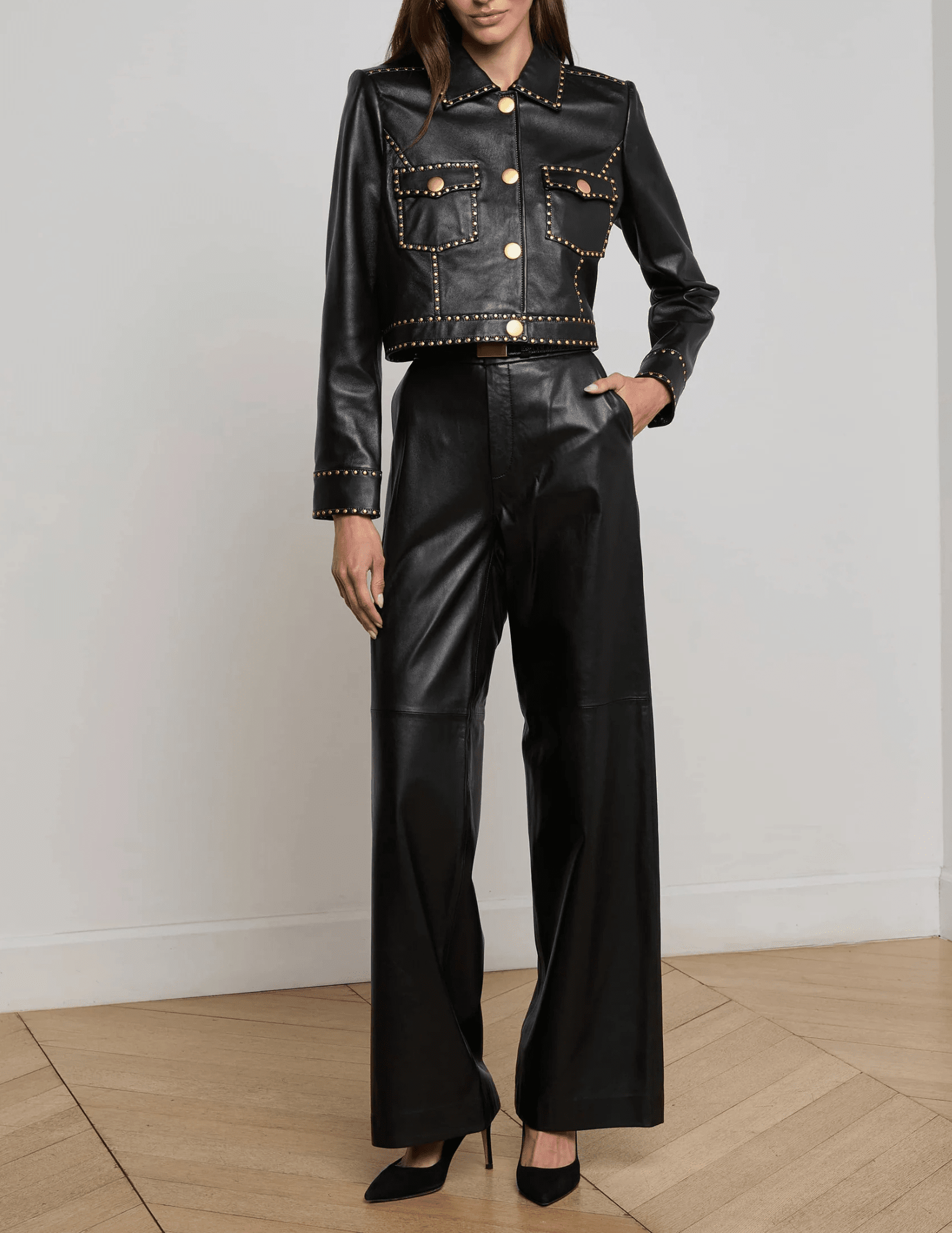 Model styling the L’AGENCE Winsome black studded leather jacket with pants