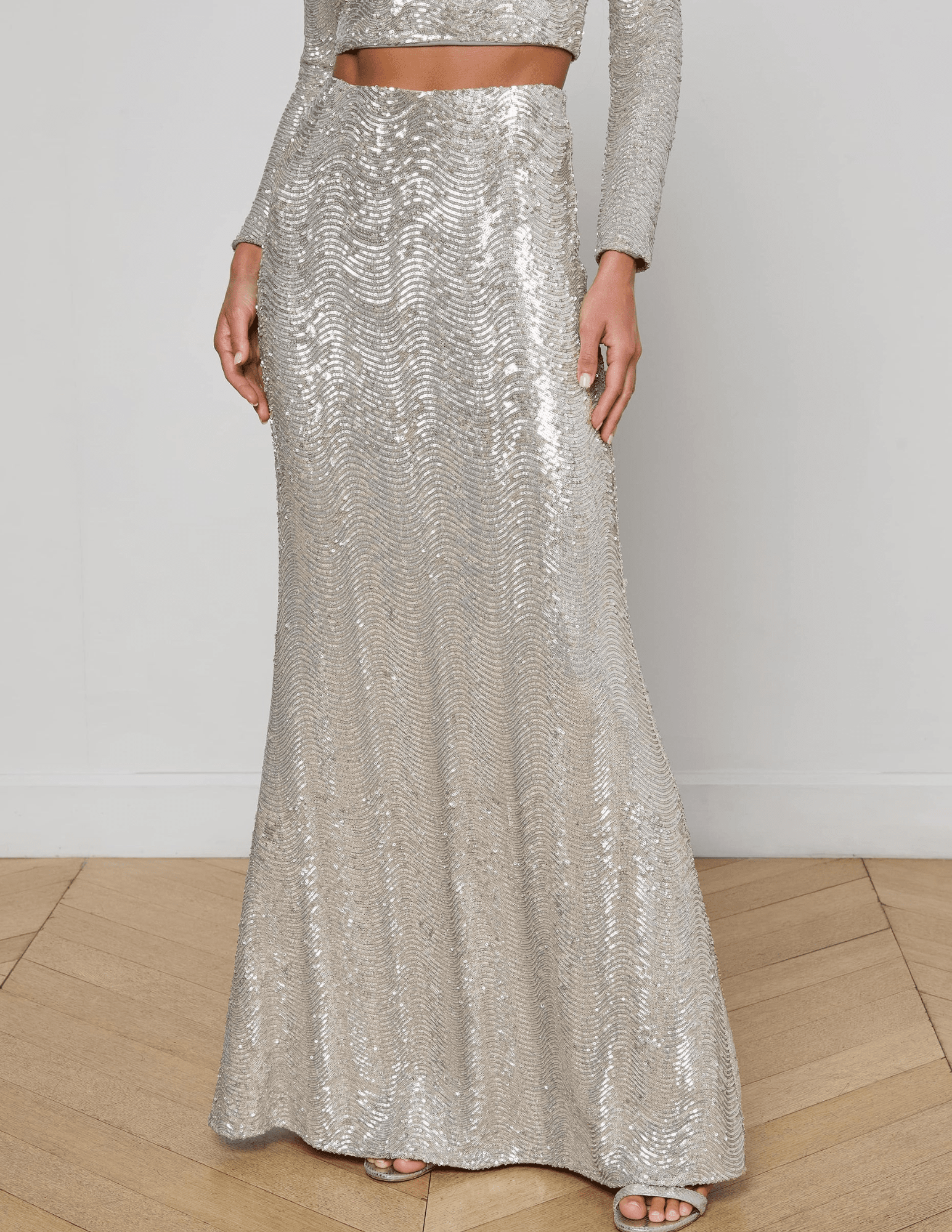 “Front view of L’AGENCE Zeta Sequin Maxi Skirt in shimmering silver swirl sequins.”