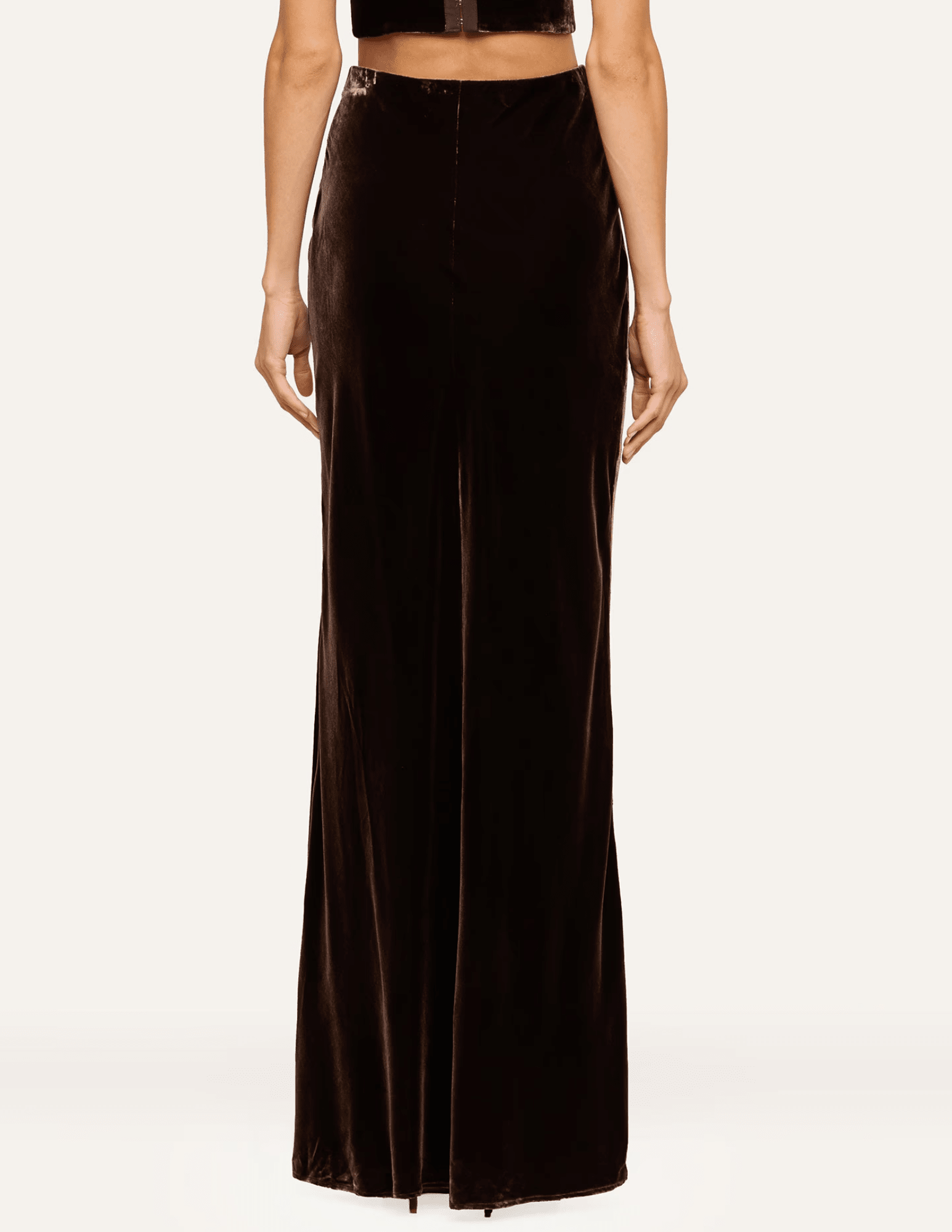 Back view of L'AGENCE Zeta Velvet Maxi Skirt in Dark Java featuring a sleek floor-length silhouette.