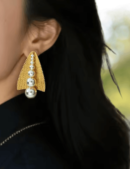 tatement gold and pearl Pia Earrings styled on model