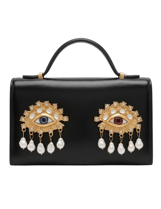 Maison Verrou Imogen Eyes Clutch in black leather with gold-tone jeweled eye and pearl embellishments.