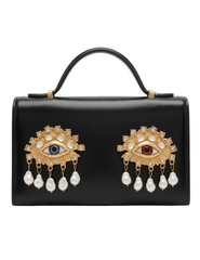 Maison Verrou Imogen Eyes Clutch in black leather with gold-tone jeweled eye and pearl embellishments.