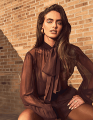Lifestyle image of Retrofête Hasli Silk Chiffon Blouse in Mahogany