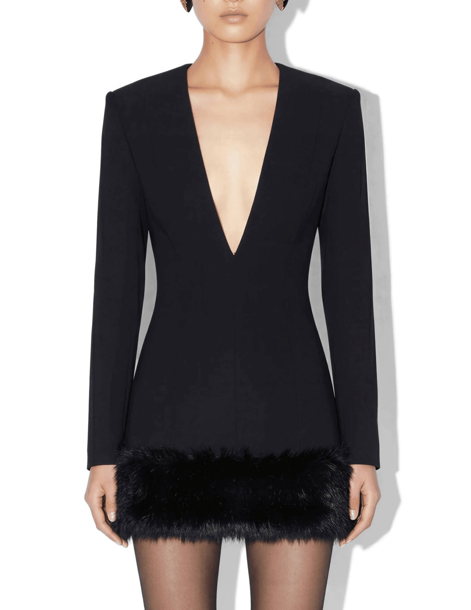 Model wearing Ronny Kobo Aivy black tailored mini dress with deep V-neckline and faux fur hem