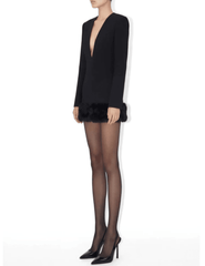 Side view of Ronny Kobo Aivy black stretch crepe mini dress styled with sheer tights and heels