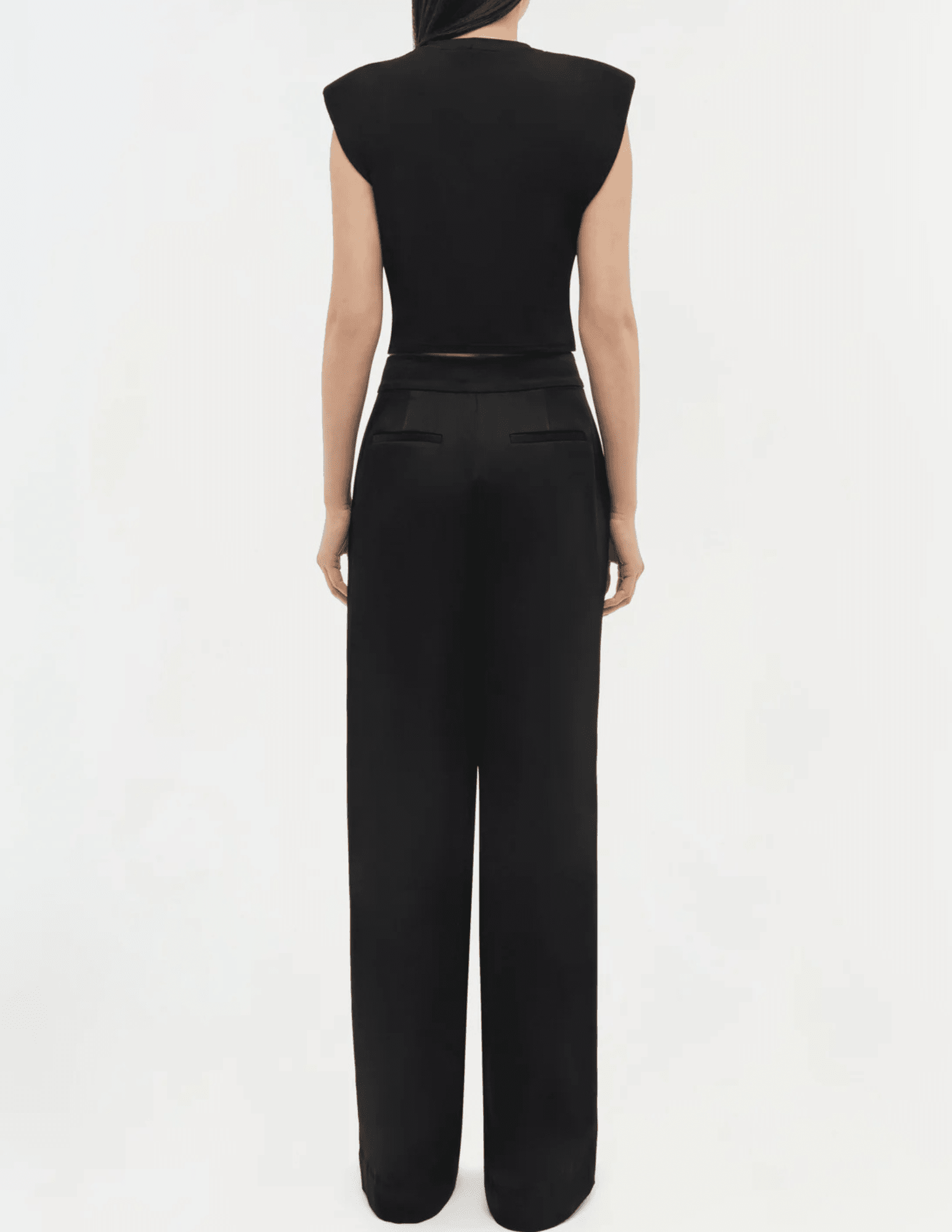 Back view of Simkhai black stretch jersey crop top