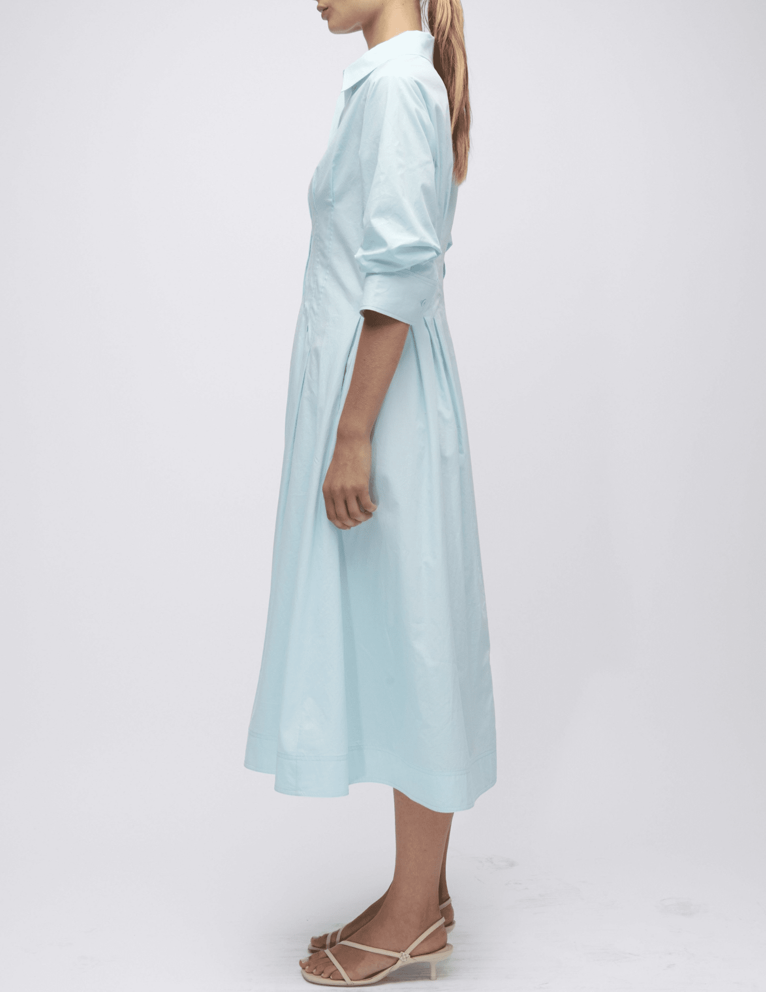 Side view of sky blue Simkhai midi dress with A-line shape