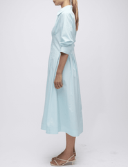 Side view of sky blue Simkhai midi dress with A-line shape