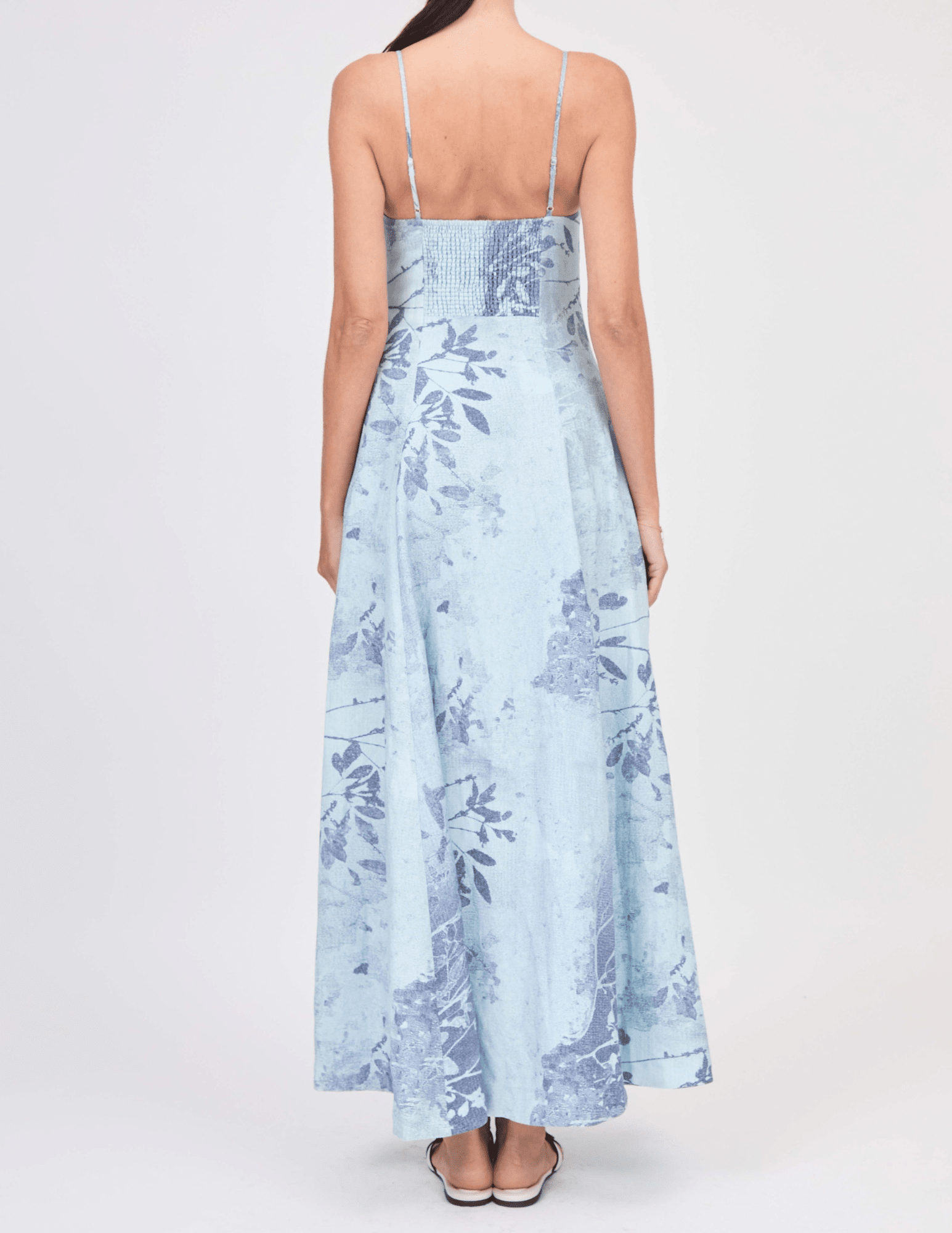Back view of sky floral Simkhai bustier maxi dress with shirred back