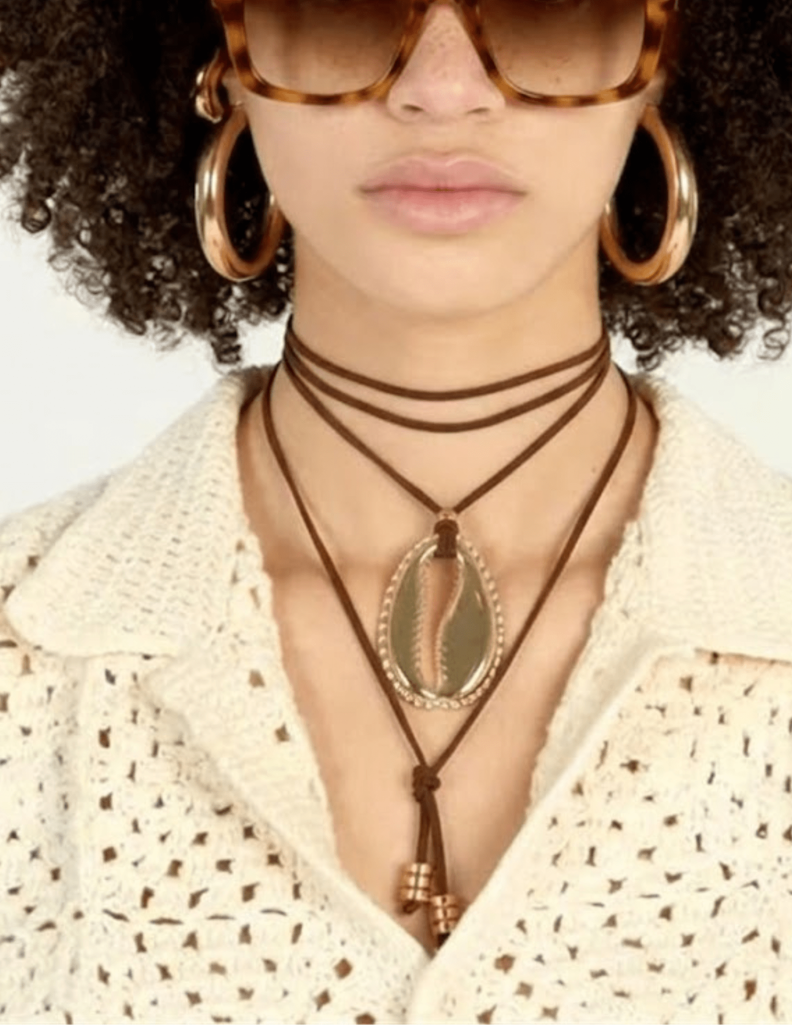 Adjustable brown wrap necklace with statement gold cowrie shell pendant