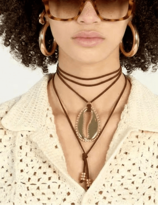 Adjustable brown wrap necklace with statement gold cowrie shell pendant
