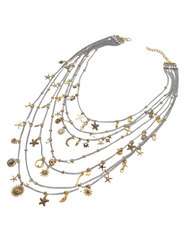 Side view of layered silver and gold charm necklace with beach-themed charms