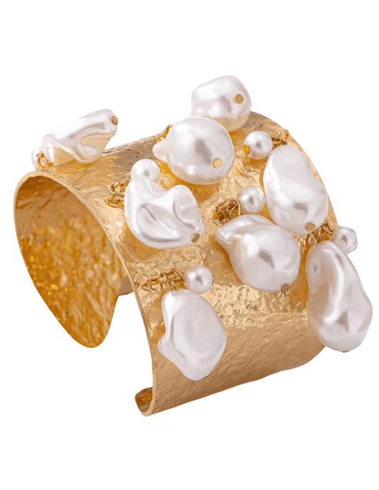 Side angle of gold-tone textured cuff with baroque pearl details