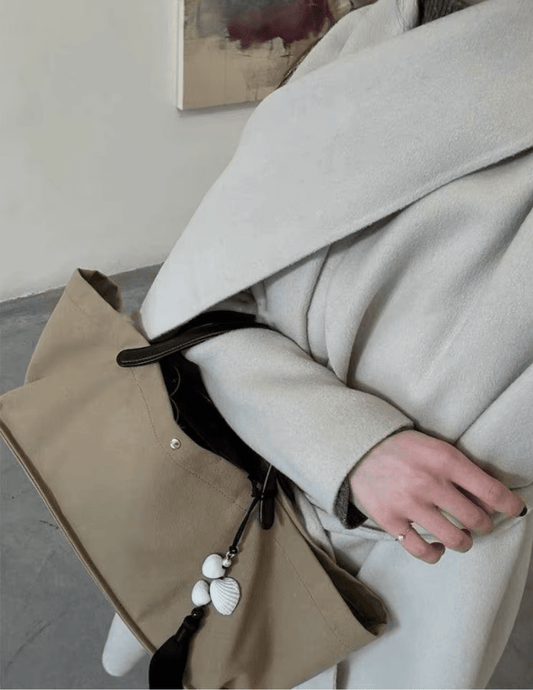 St. Barths La Robe Leah seashell tassel bag charm styled on handbag