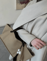 St. Barths La Robe Leah seashell tassel bag charm styled on handbag