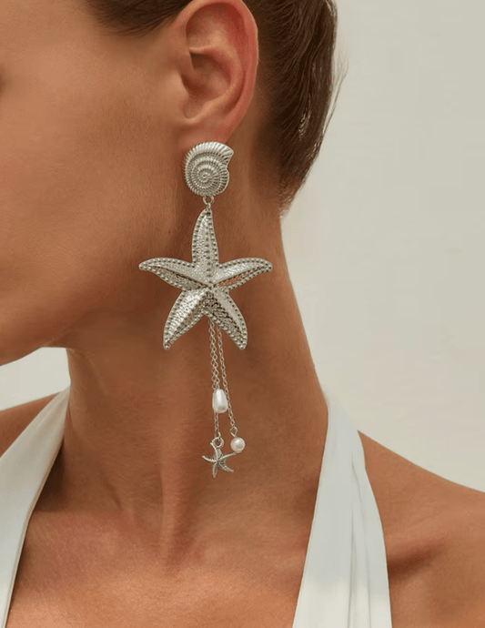 Model wearing St Barths silver starfish statement earrings
