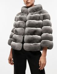 Model wearing Steven Dann Lissy Rex Fur Jacket in Natural with stand collar and short sleeves